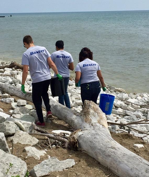 Baxter employees cleaning pool area and beach